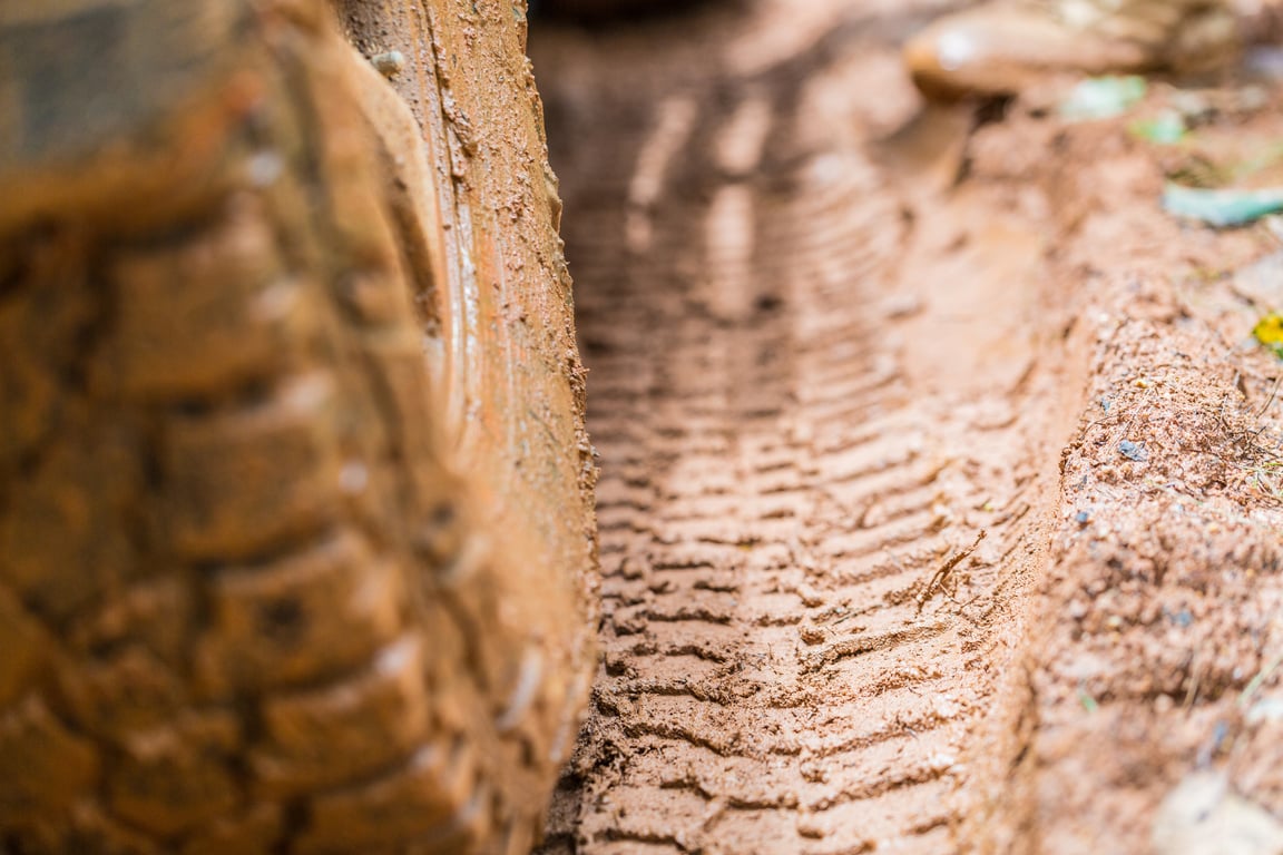 Off-road tires, Dirty offroad car, SUV covered with mud on countryside road.  offroad travel  and driving concept.